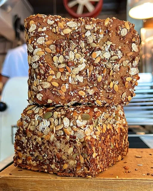 TestKitchen whole grain loaf stacked on a wooden board